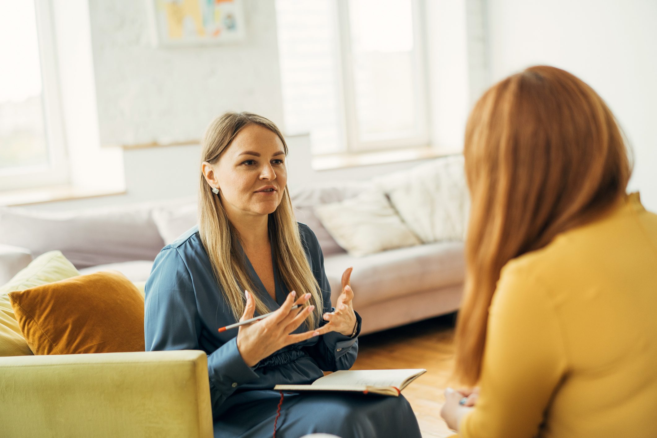 A psychiatrist conveys mental health information to her partially unseen patient.